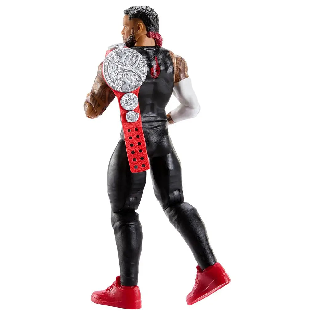 Rear angled view of the WWE Jey Uso action figure shows the silver belt draped over his shoulder, revealing tattooed arms, black attire, red shoes, and articulated joints in a white studio setting.