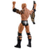 Rear angled view of The Rock WWE action figure reveals sculpted tribal tattoos, black boots, raised fists, and gold-trimmed championship belt details displayed in a bright white studio setting.
