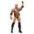 WWE The Rock action figure raises a gold-trimmed championship belt, showing muscular sculpting, black trunks, detailed tribal tattoos, and smooth articulated plastic against a clean white studio backdrop.