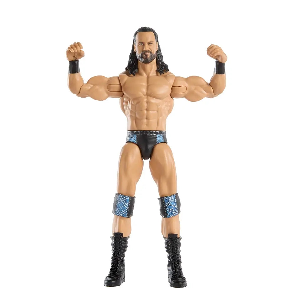 WWE Drew McIntyre poseable action figure with raised arms, muscular tan body, black trunks with blue patterning, knee pads, and lace-up boots, demonstrating articulation for signature power poses against a clean white background.
