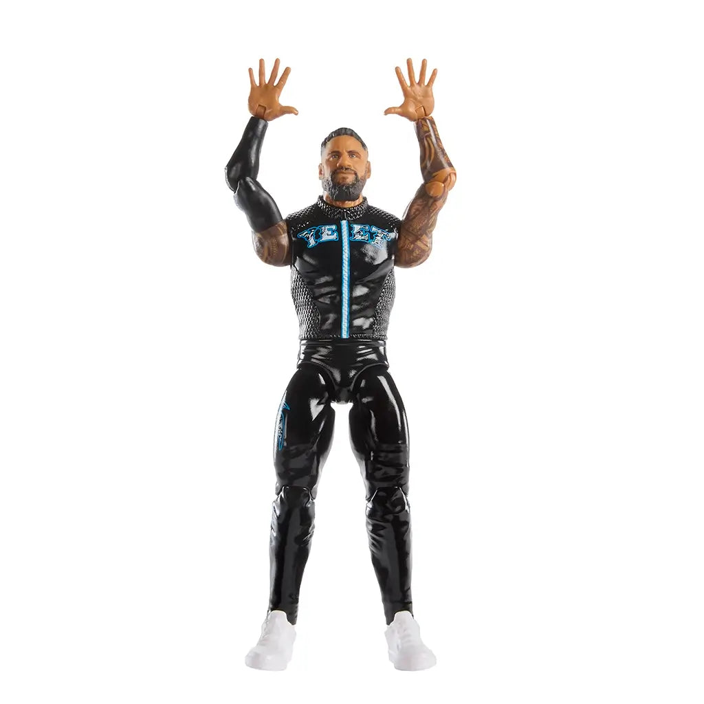 WWE Jey Uso poseable action figure with raised arms, black shiny pants, blue graphic details, molded tattoos, and white boots, demonstrating articulation for signature wrestling poses against a plain white backdrop.