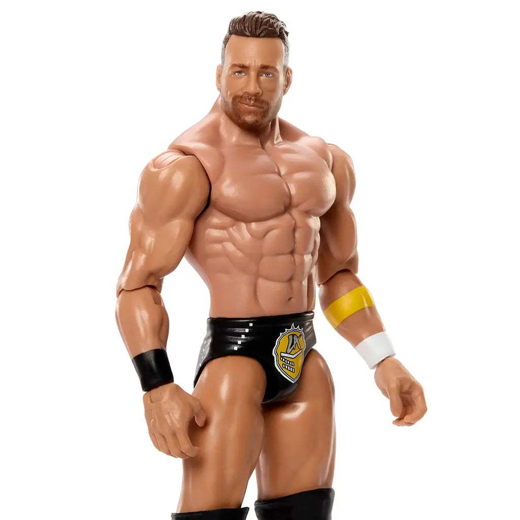 WWE Main Event Series LA Knight wrestling figure close-up showing tan plastic muscular build, defined chest and abs, short brown molded hair, trimmed beard, black trunks with gold logo, wristbands, and confident expression on a white background.