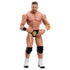 WWE Main Event Series LA Knight wrestling figure poseable view showing tan plastic body, sculpted muscular form, black knee pads, white boots, gold logo trunks, articulated joints, and hands-on-hips stance on a white studio background.