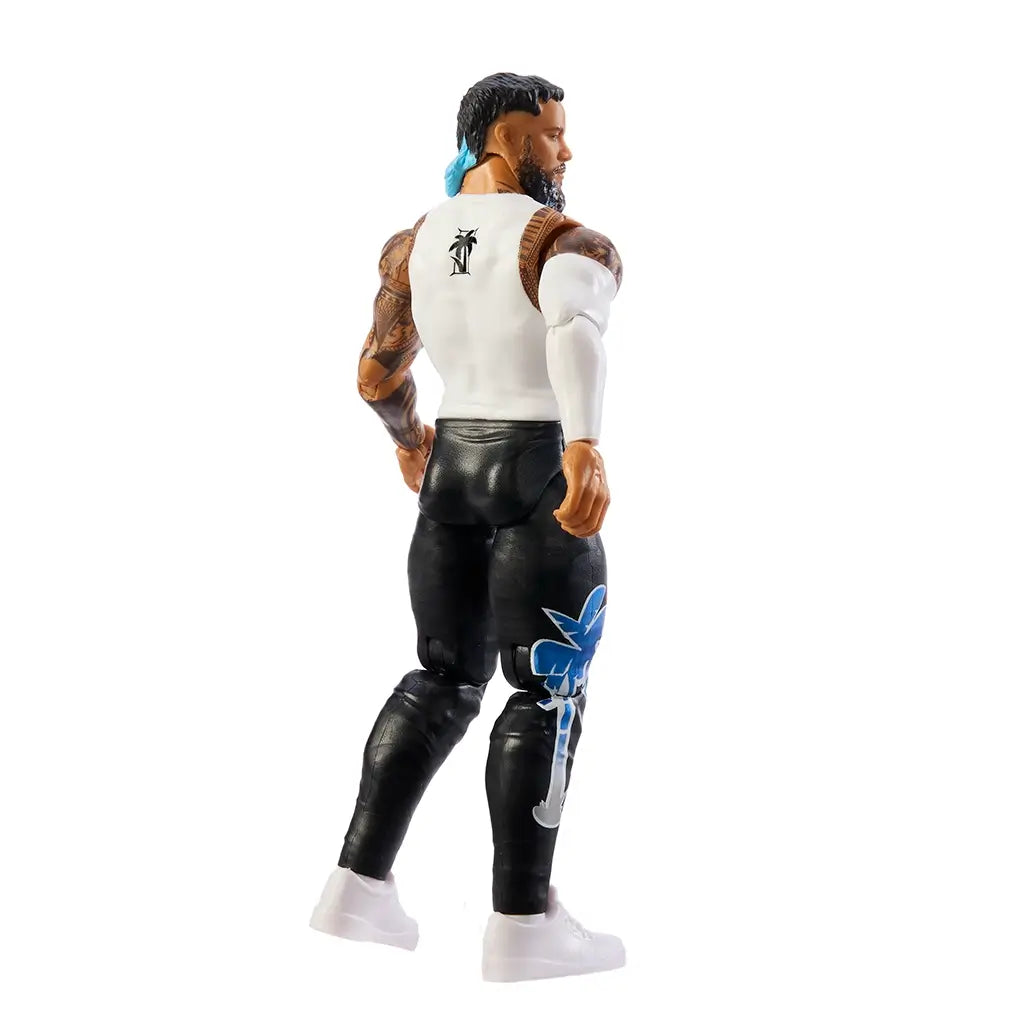 WWE Jey Uso action figure rear angled view with medium tan glossy plastic surface, sculpted back and tattoo details, articulated limbs and black pants, emphasizing poseability on a clean white studio background.