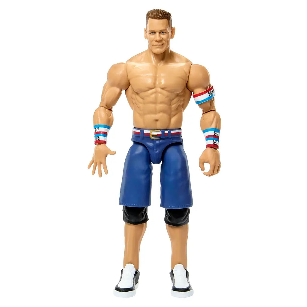 WWE John Cena action figure with tan skin tone, glossy molded plastic material, muscular human shape, red white and blue wristbands with blue shorts, designed for poseable wrestling play on a clean white studio background.