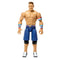 WWE John Cena action figure with tan skin tone, glossy molded plastic material, muscular human shape, red white and blue wristbands with blue shorts, designed for poseable wrestling play on a clean white studio background.