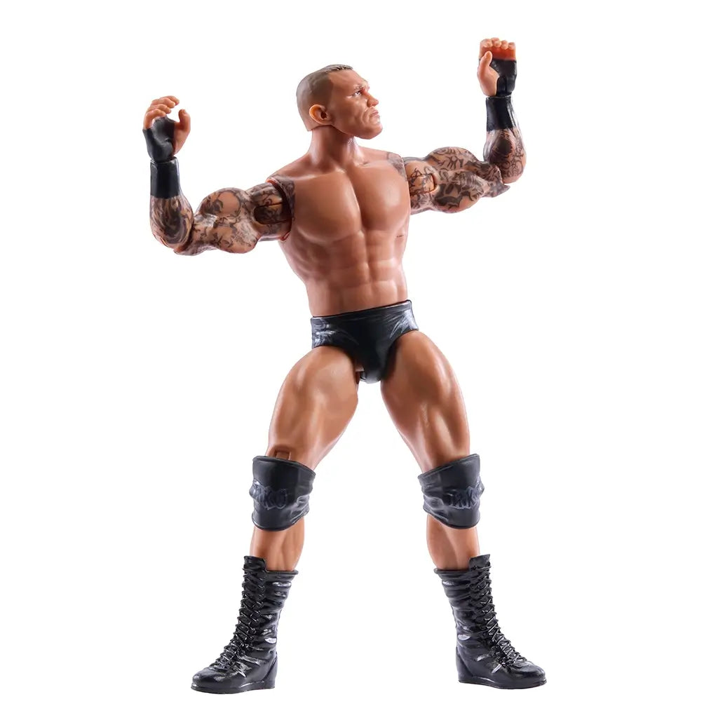 WWE Randy Orton poseable action figure flexing arms, highlighting muscular tan body, full-sleeve tattoo detailing, black trunks and knee pads, and flexible joints that allow signature wrestling poses against a clean white background.