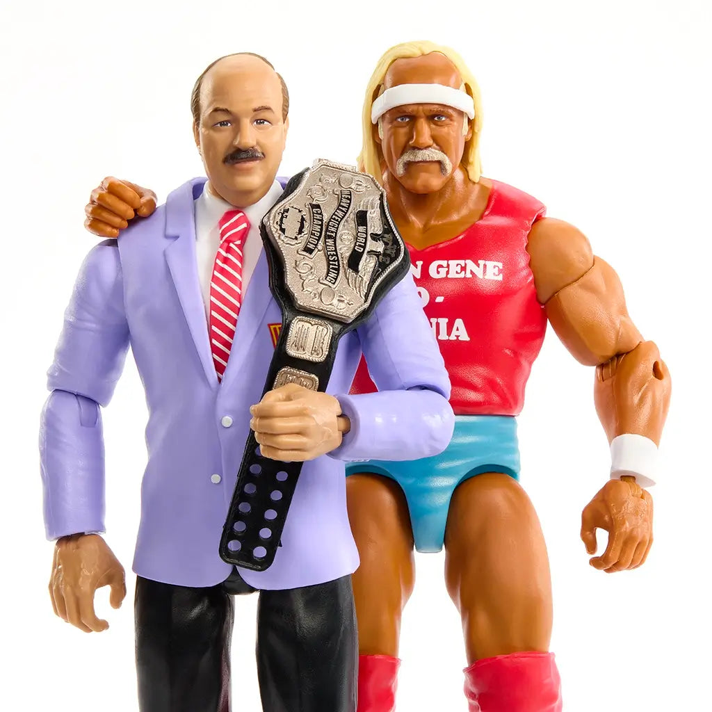 WWE action figures of Hulk Hogan in a red tank top and turquoise trunks with championship belt stand beside Mean Gene Okerlund in a lavender blazer holding the same title belt.