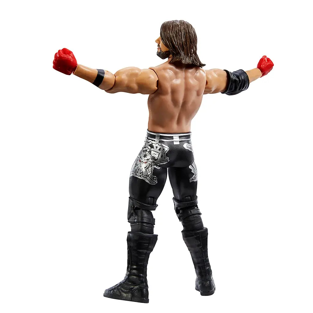 Rear angled view of WWE AJ Styles action figure showing sculpted back muscles, long hair, and detailed designs on black pants with silver graphics.
