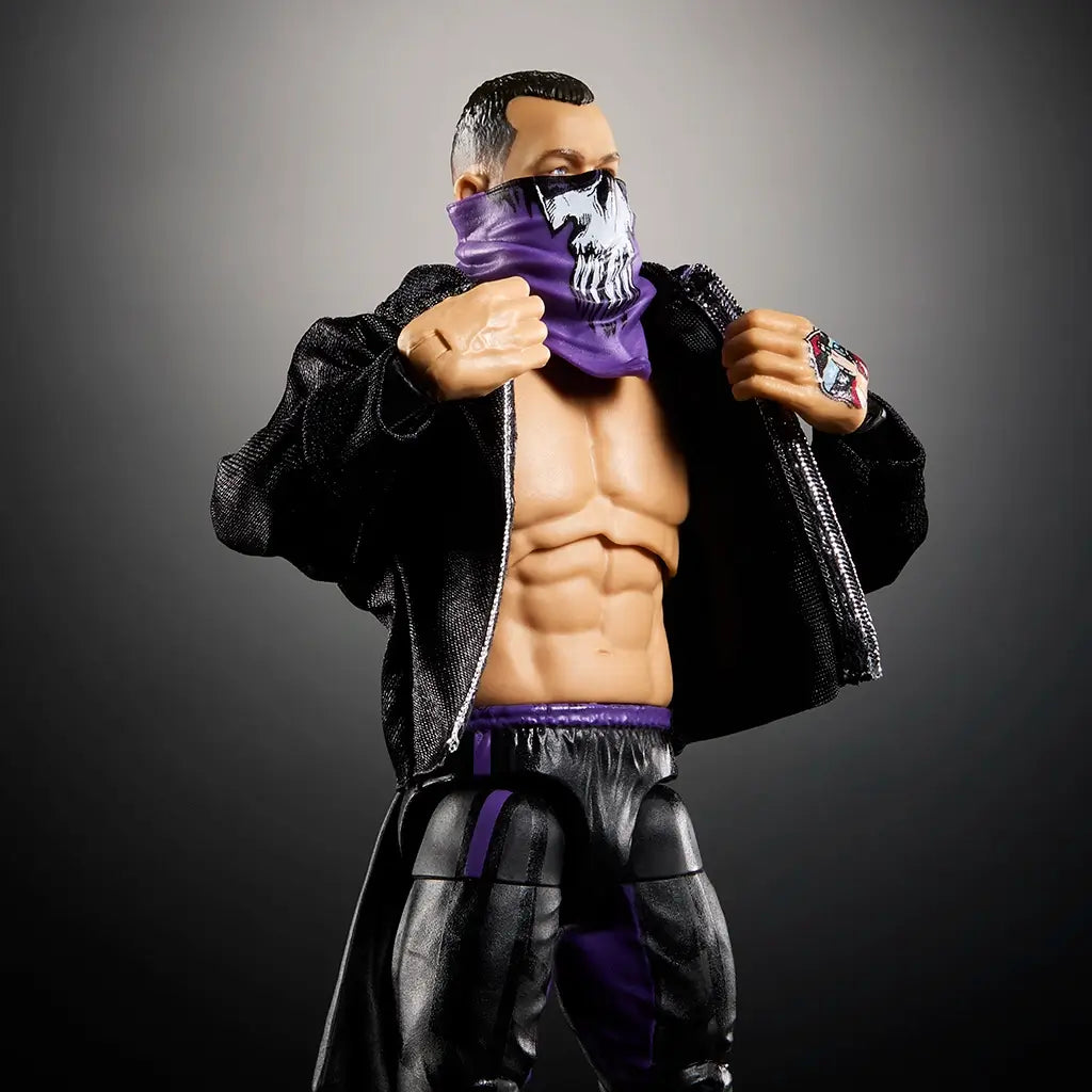 WWE Finn Bálor Ultimate Edition action figure wearing a black jacket, purple skull bandana, and showing muscular torso with black pants accented by purple highlights.