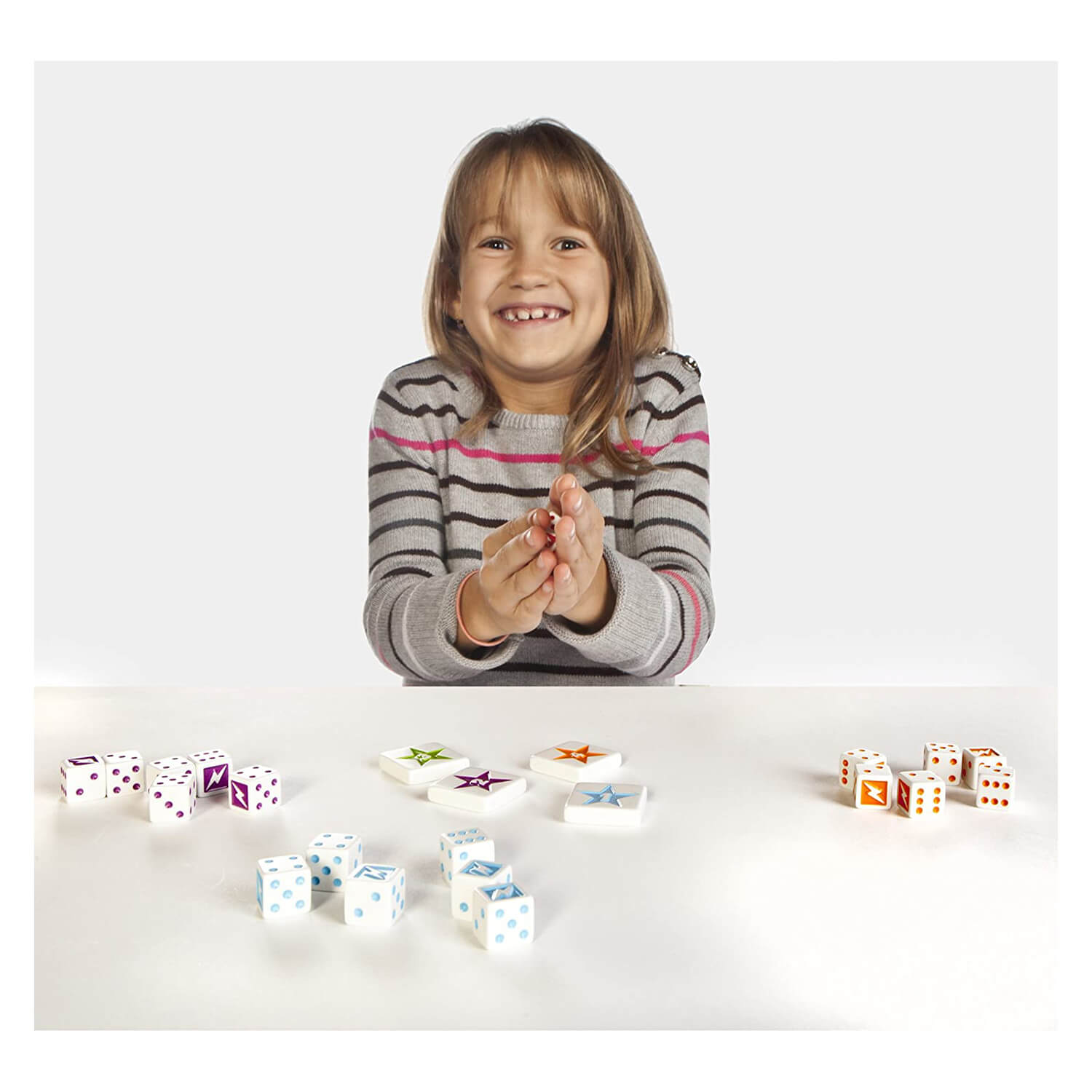 Little girl playing with dice included.