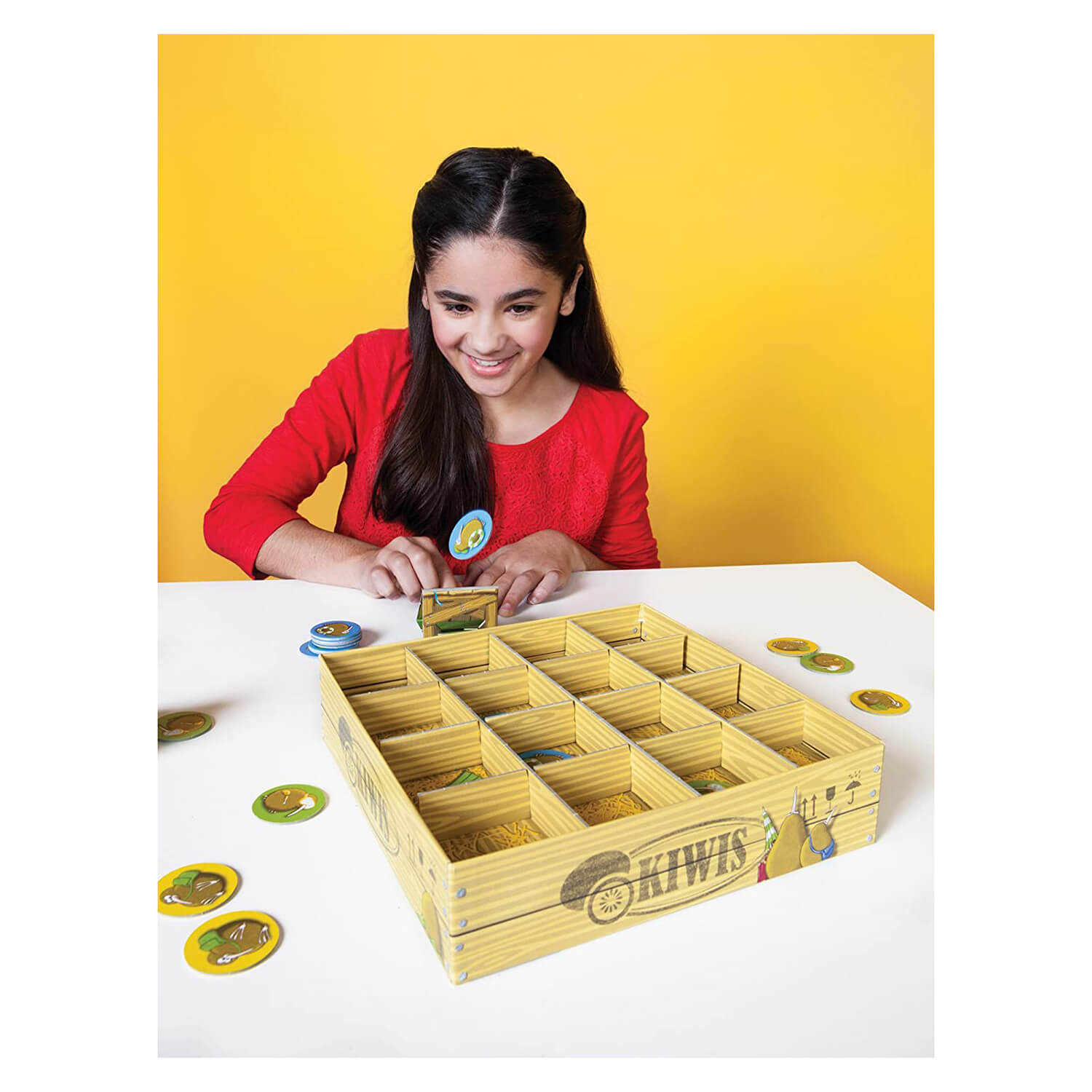 Little girl playing the flying kiwis board game.