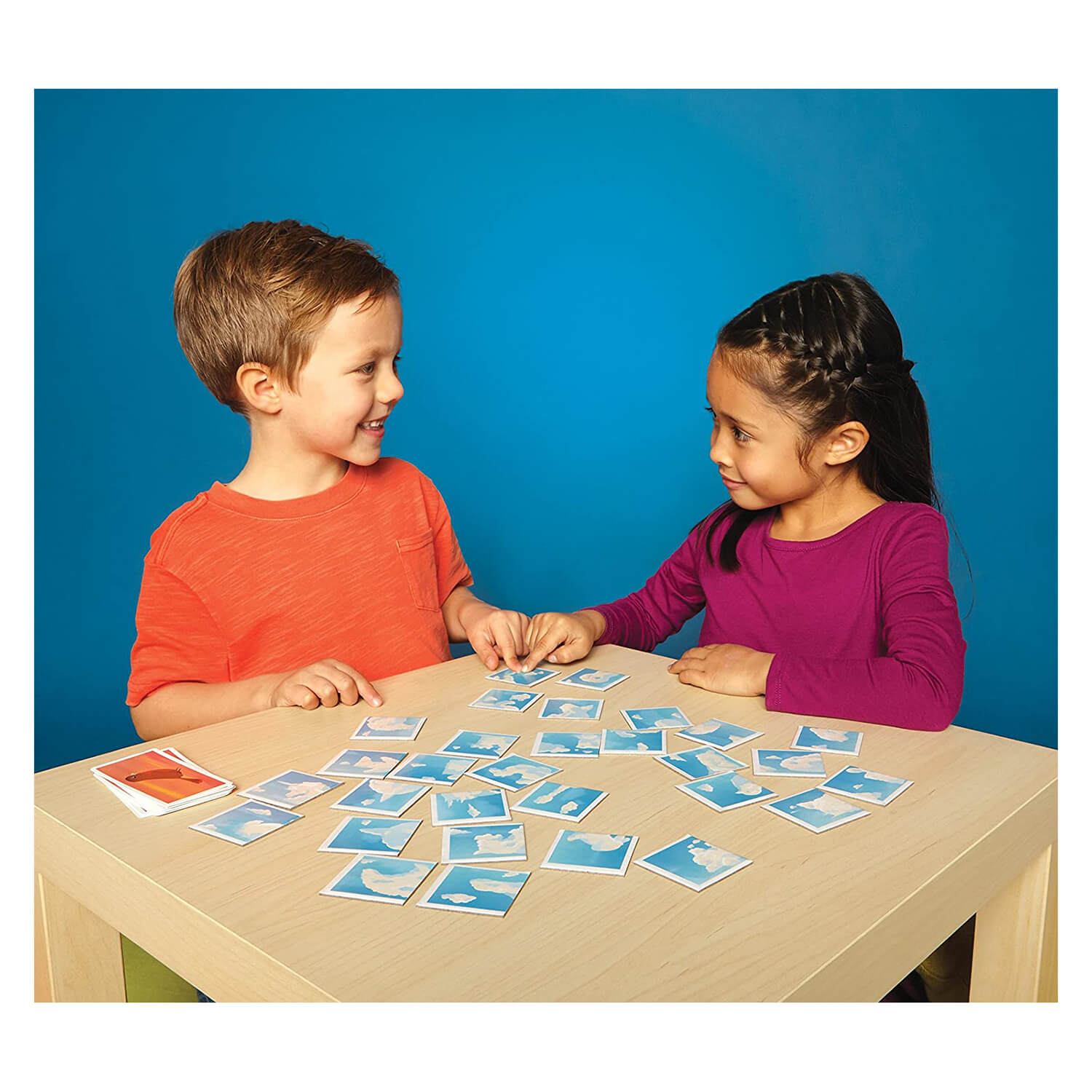 Kids playing the card game together.