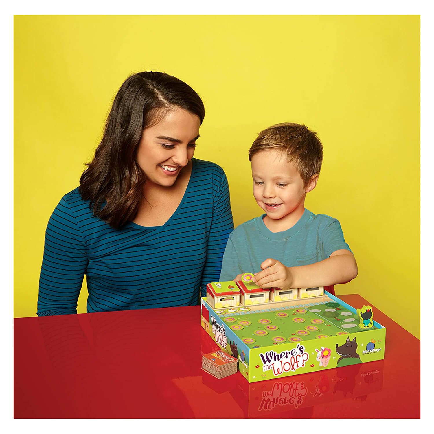 Mother and son play the fun board game together.