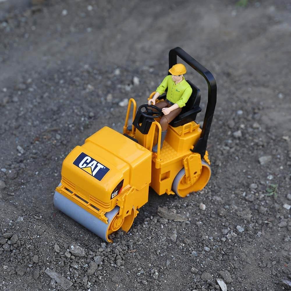 Caterpillar construction toy displayed on the asphalt with a bworld figure (not included)