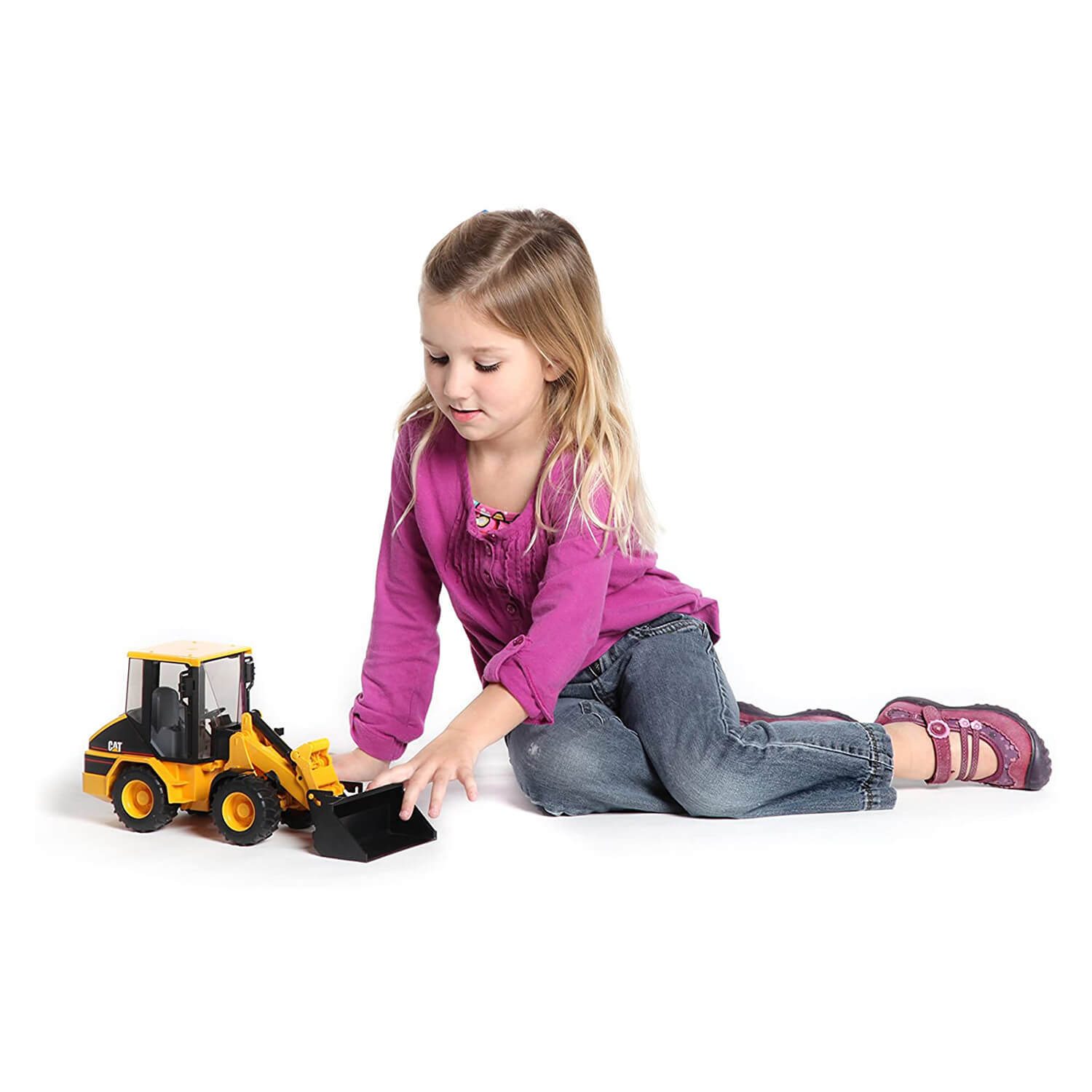 Girl playing with the bruder 02442 caterpillar wheel loader.