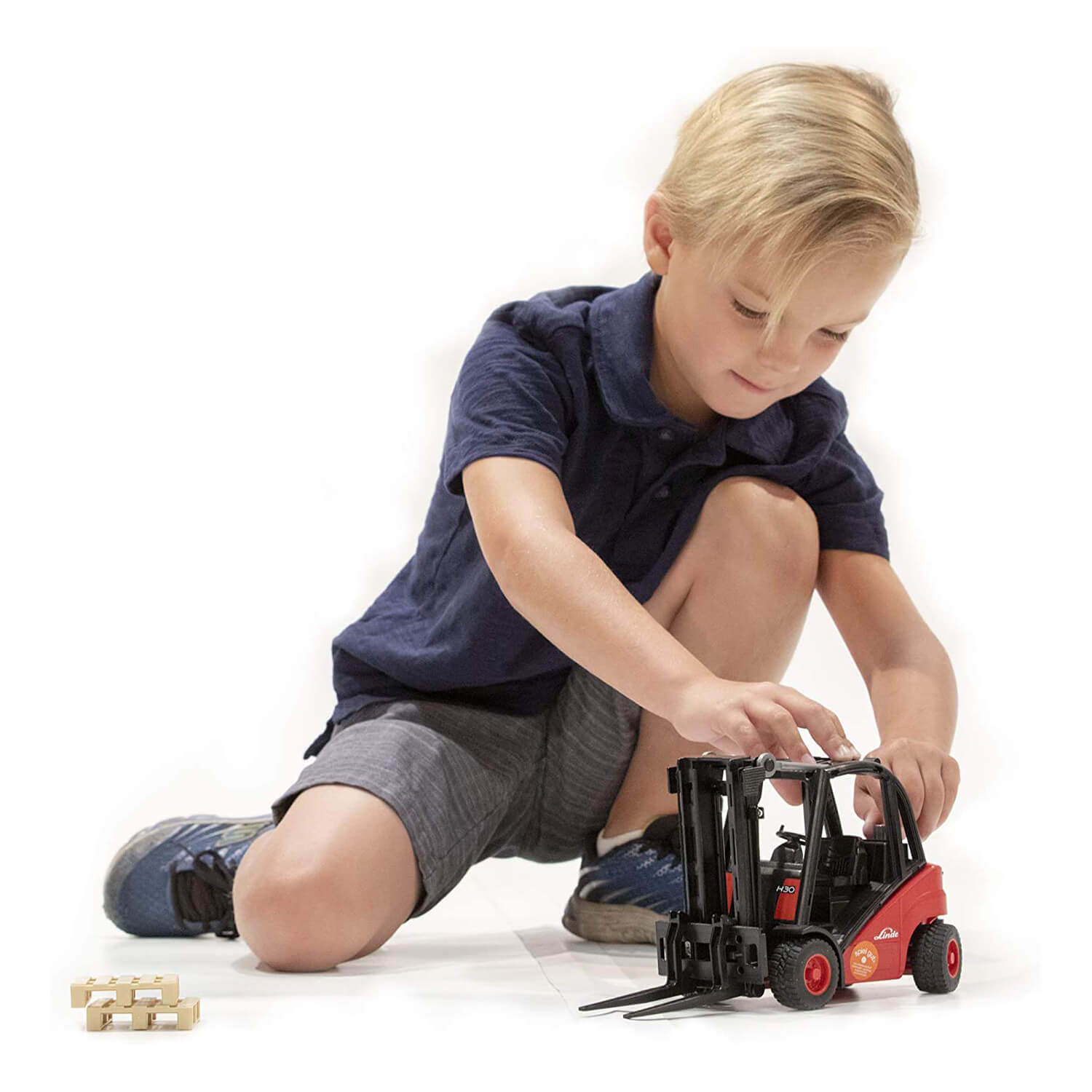 Kid playing with the forklift toy.