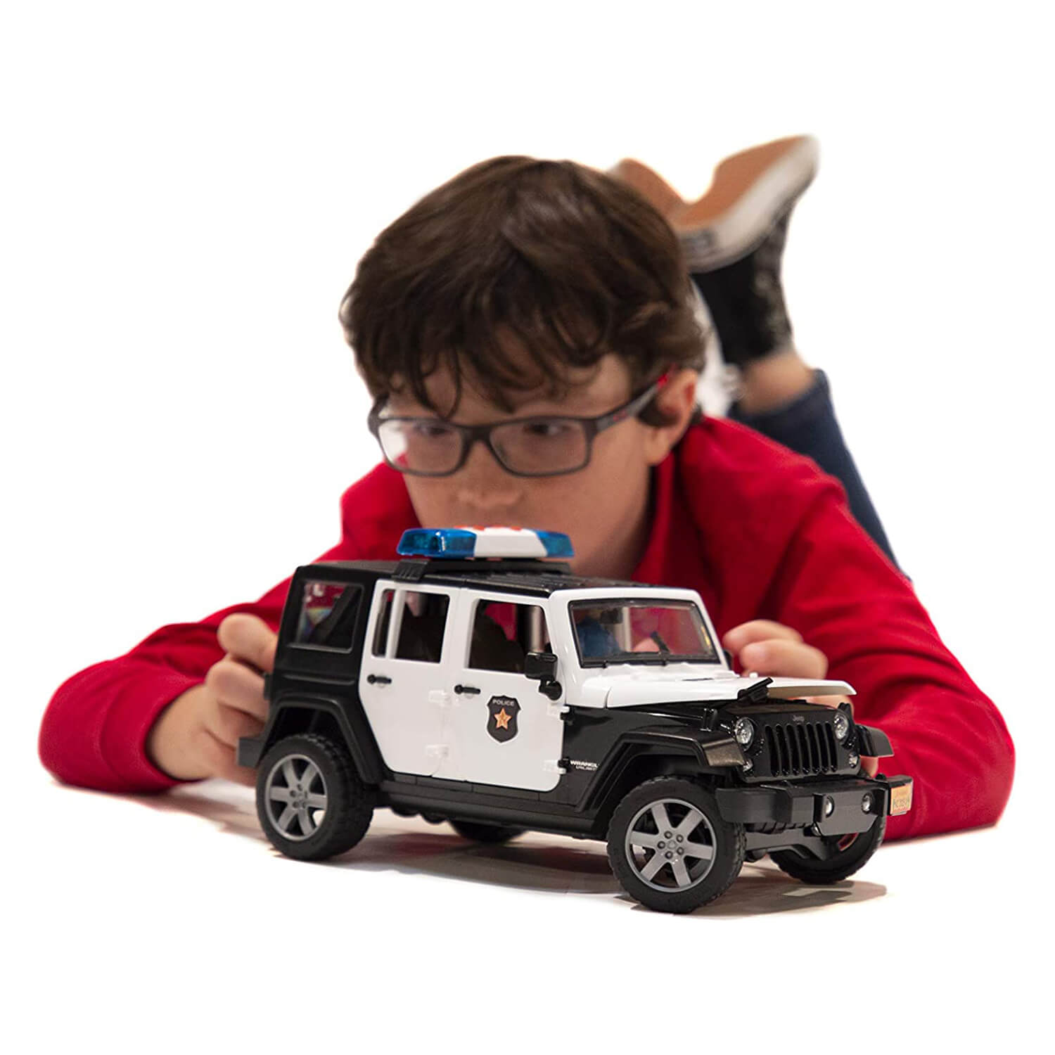 Kid playing with his jeep rubicon vehicle.
