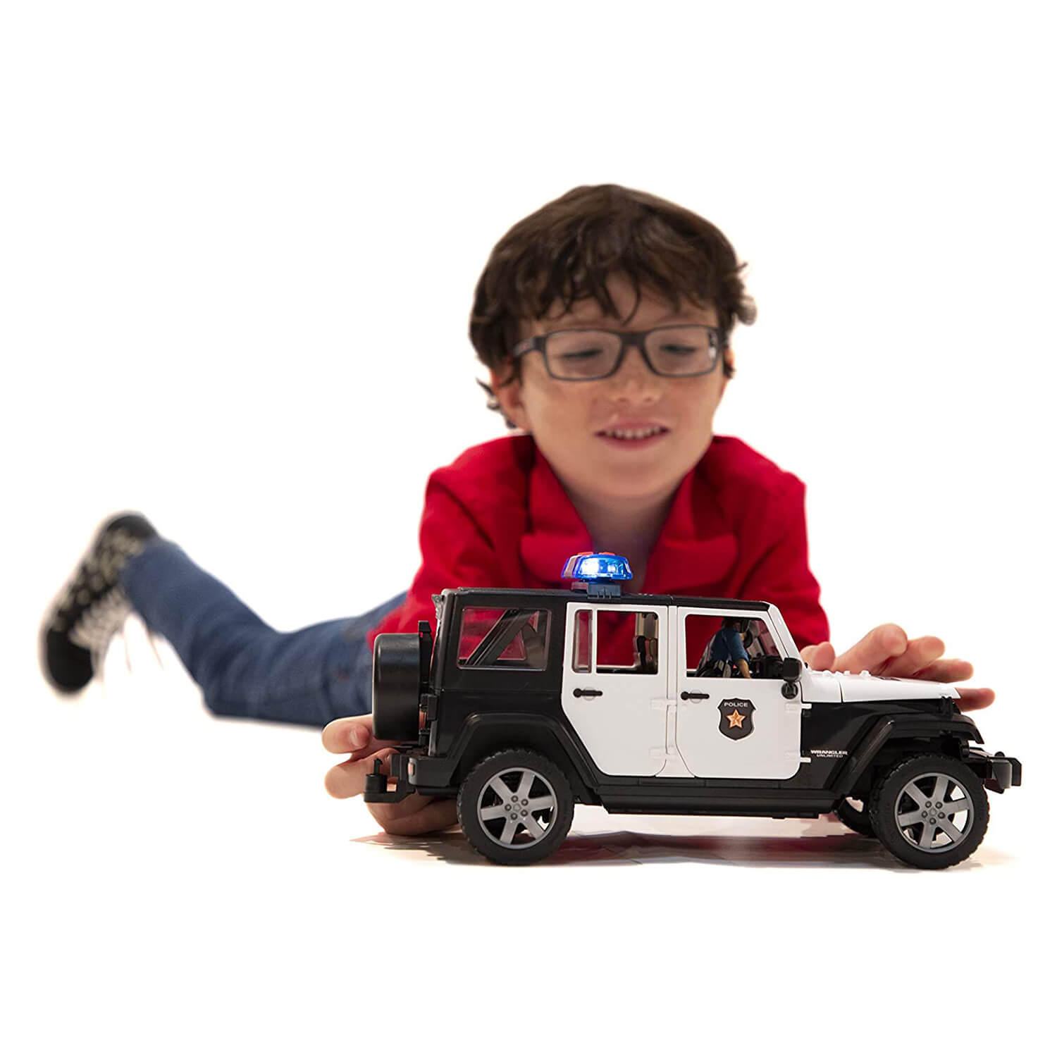 Kid playing with the police jeep toy.