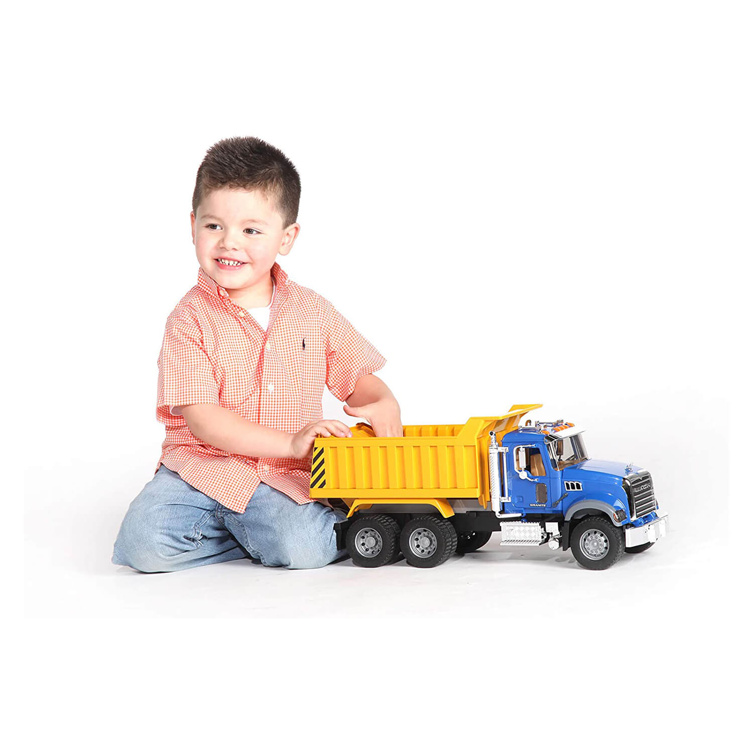 Kid playing with the mack truck toy.