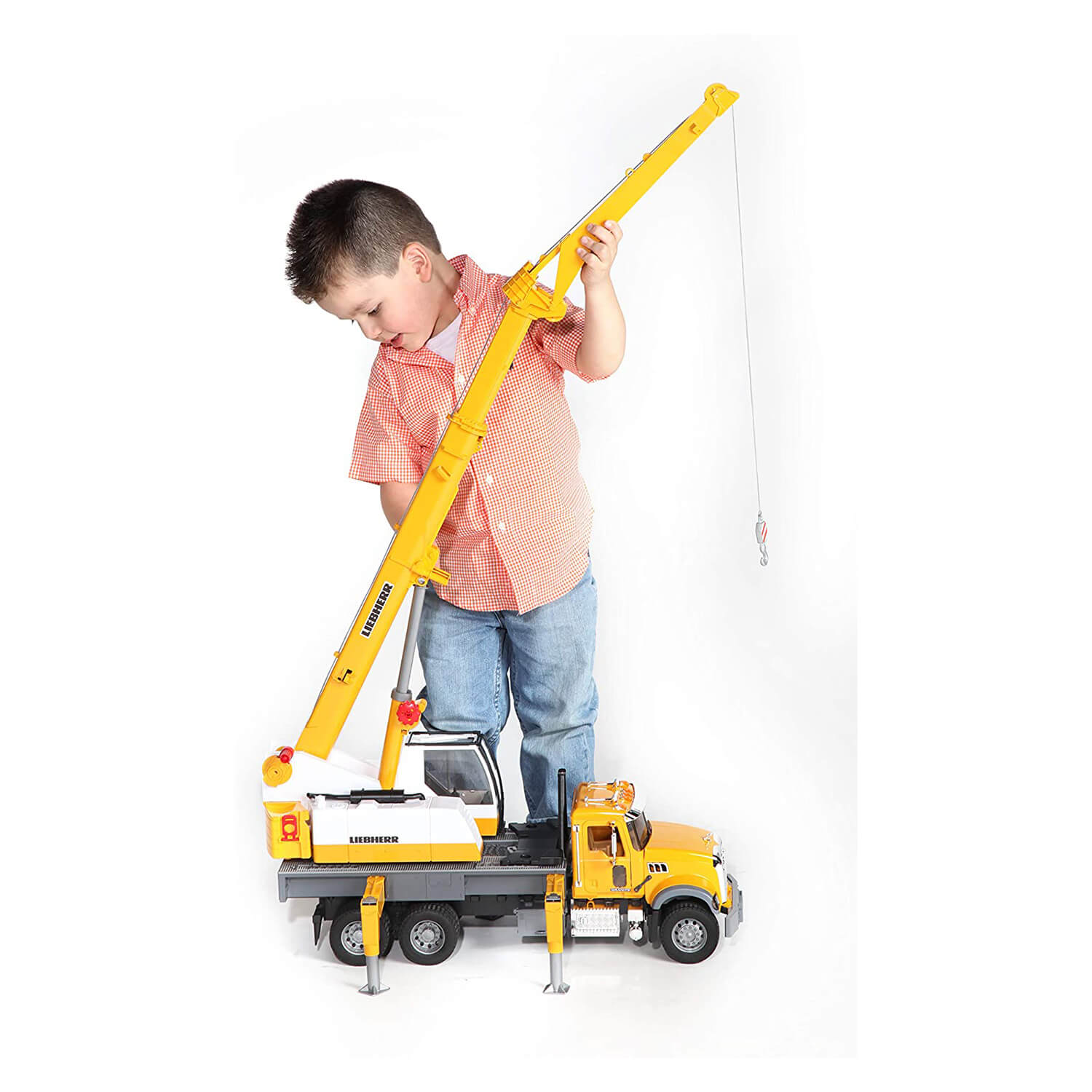Kid playing with the crane truck.