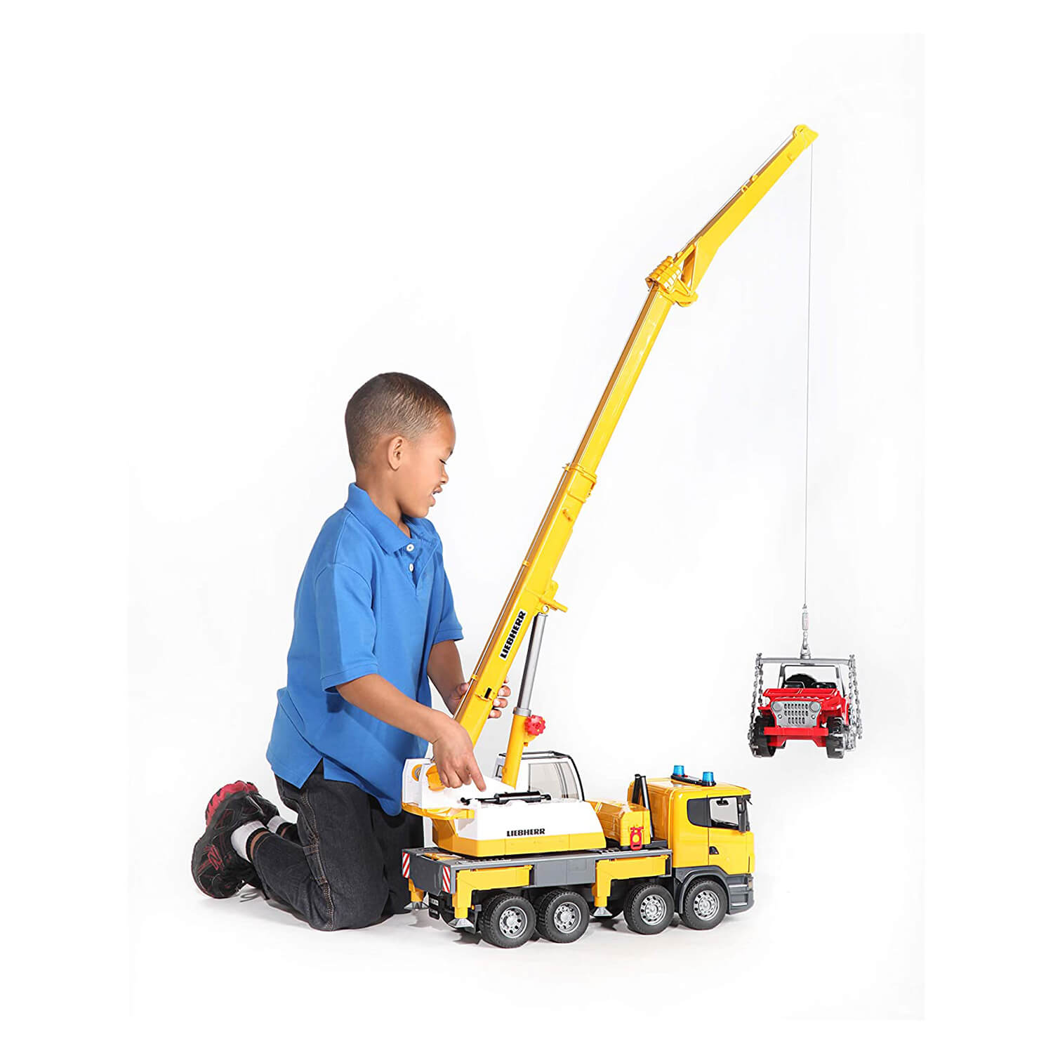 Kid playing with the crane toy.