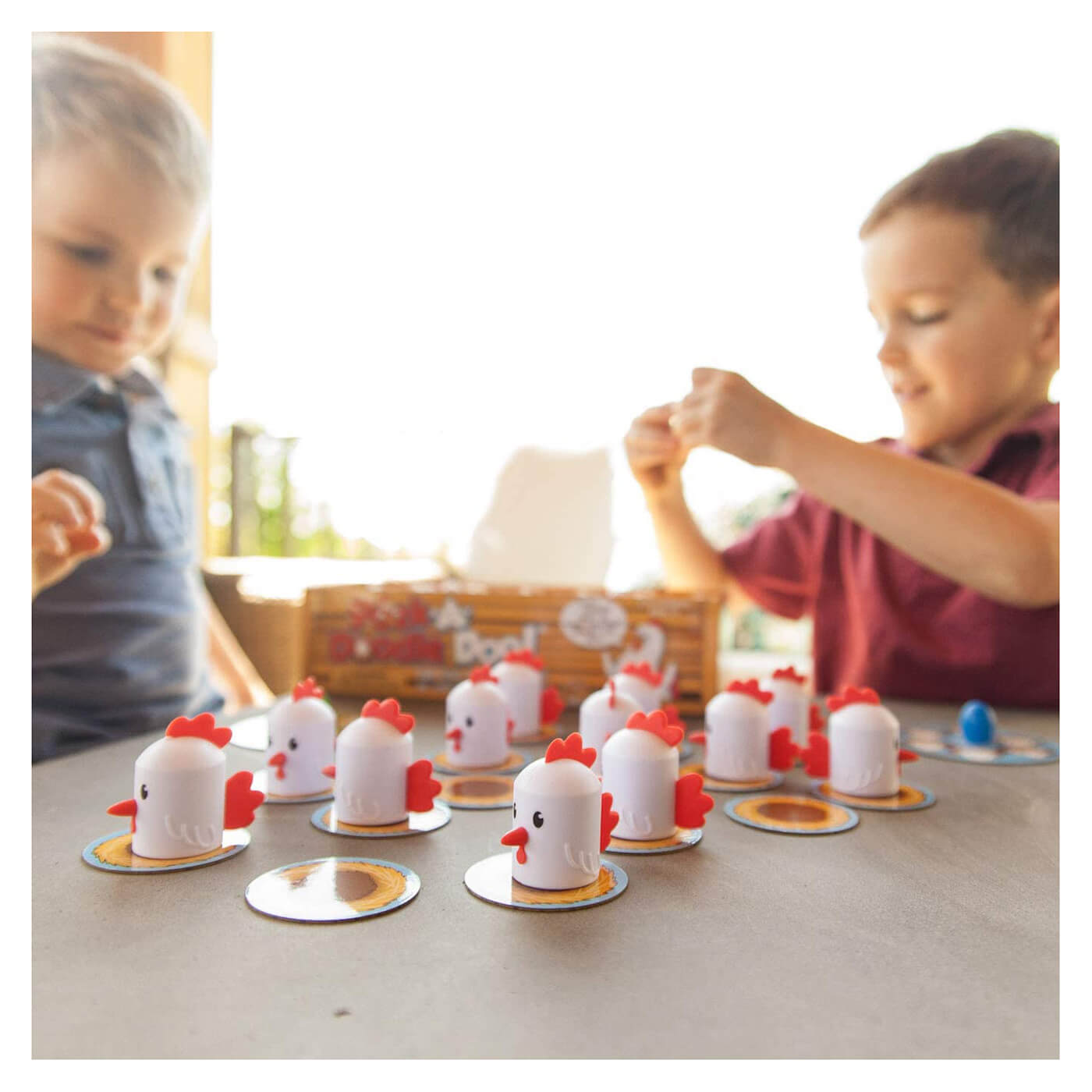 Kids playing with the Fat Brain Toys Peek-A-Doodle Doo.