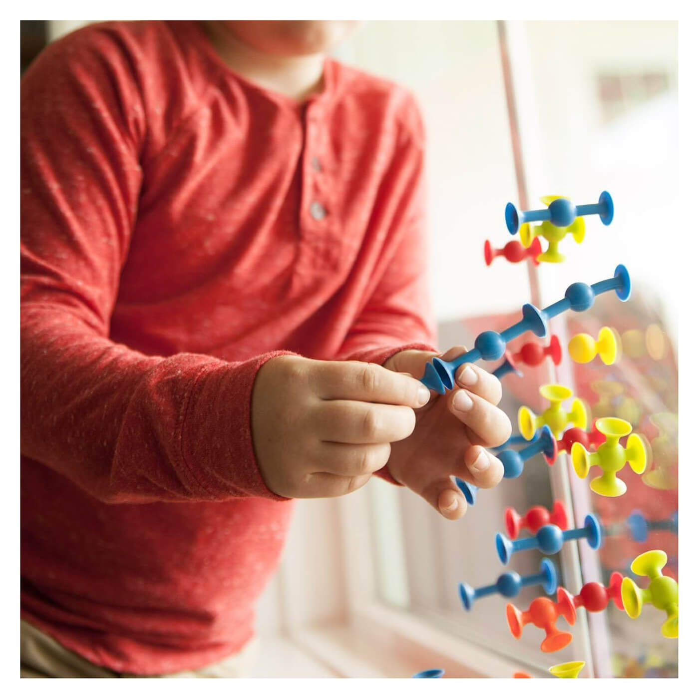 Kid playing with the Fat Brain Toys MiniSquigz.