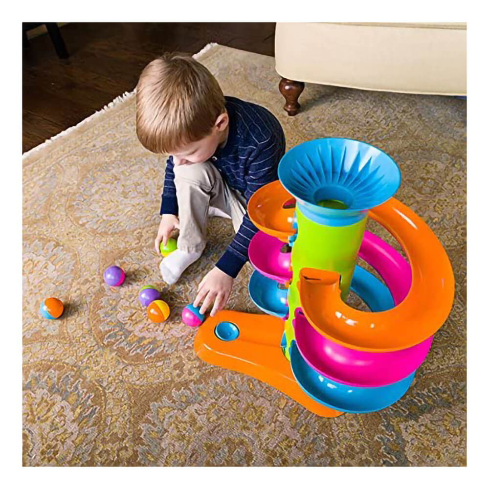 Kid playing with the Fat Brain Toys RollAgain Tower.
