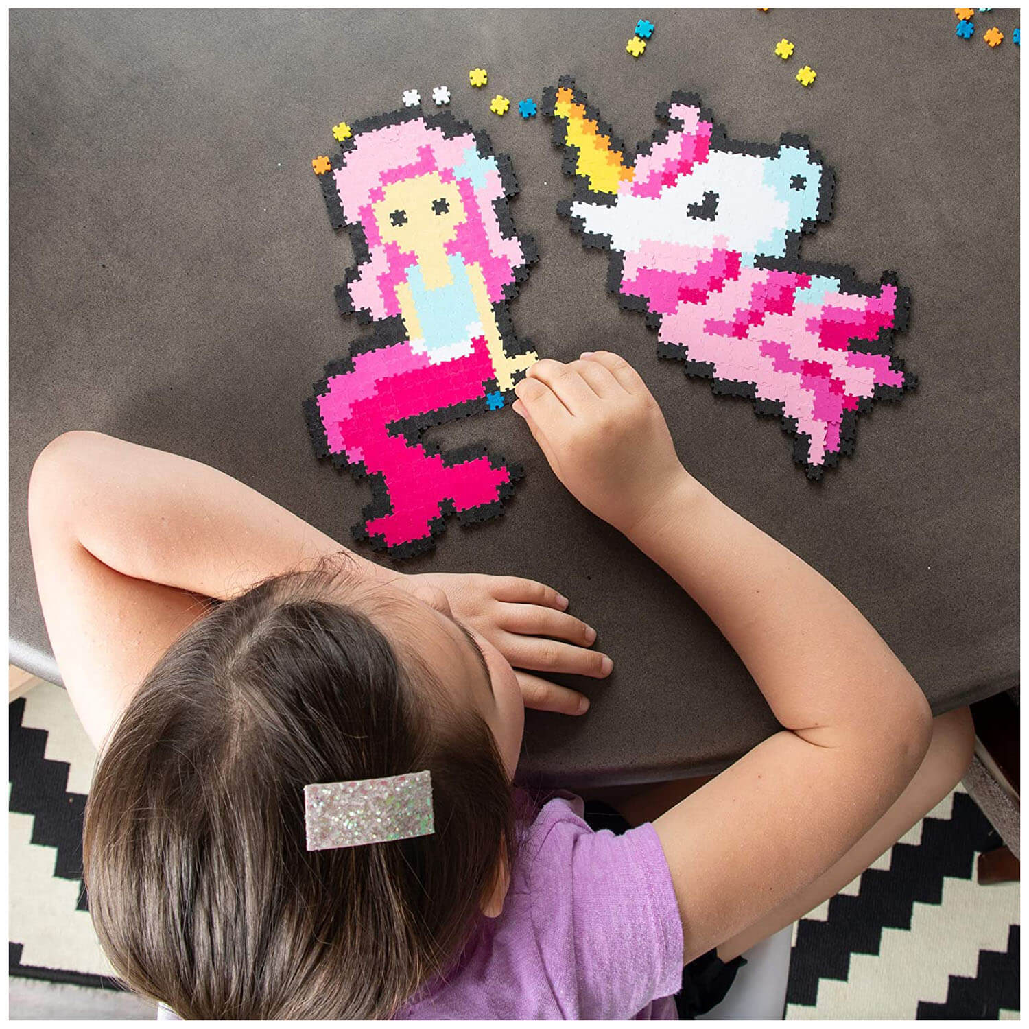 Girl building a mermaid and unicorn.