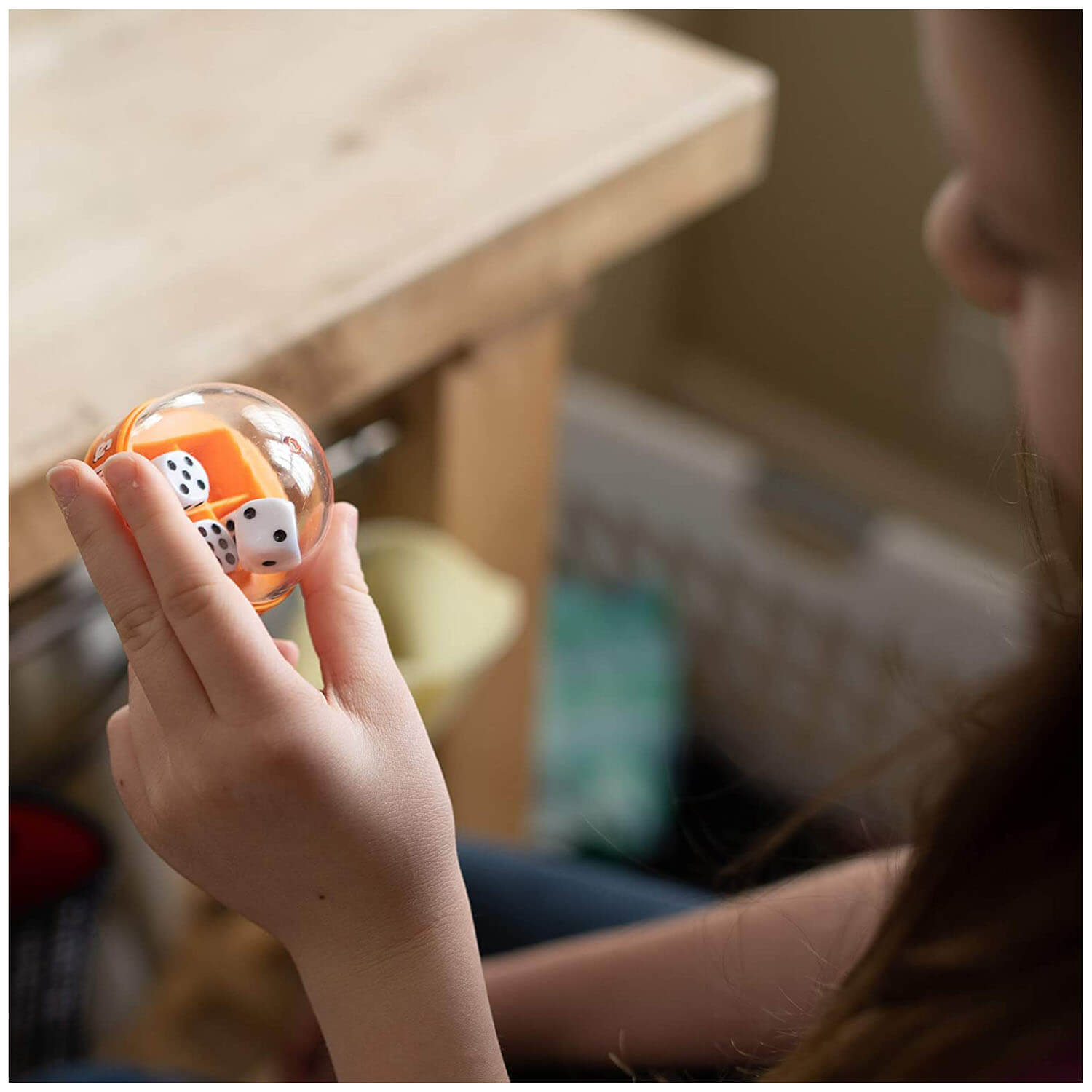Kid playing with the Fat Brain Toys Shake & Make Dice.