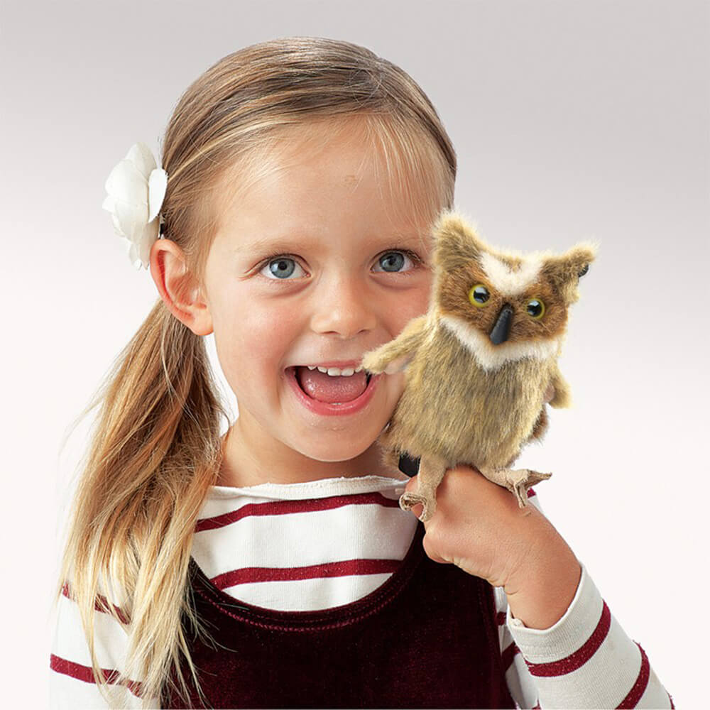 A little girl playing with the Folkmanis Mini Great Horned Owl Finger Puppet