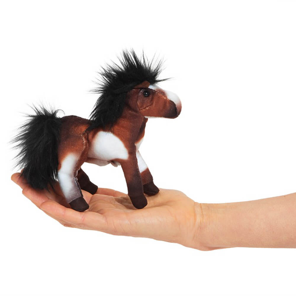 Child holding the Folkmanis Mini Horse Finger Puppet with their hand.