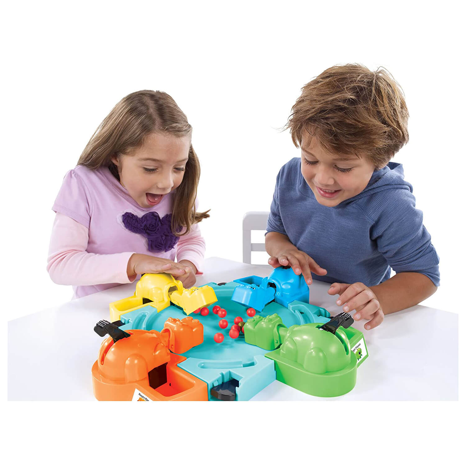 Kids playing the hungry hippos game.