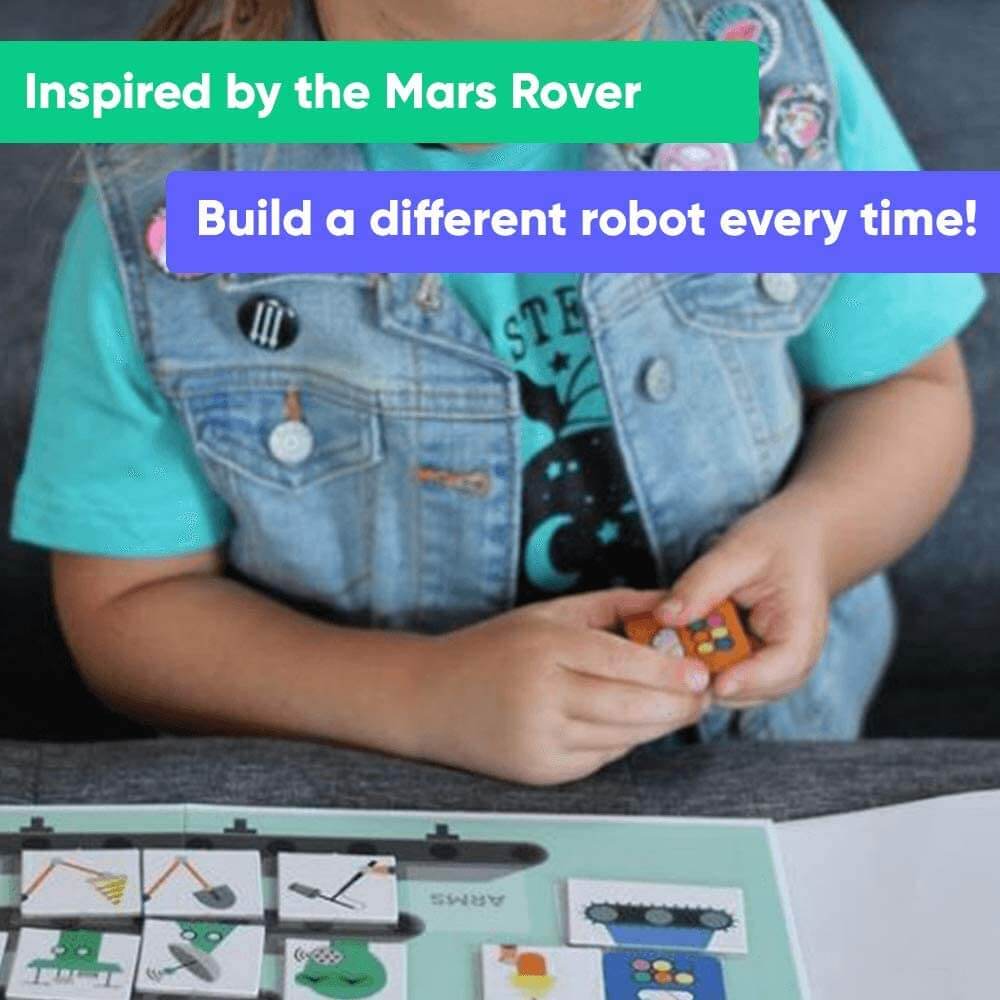 Lifestyle image of girl playing OjO Robot Workshop game which says inspired by the Mars Rover and build a different robot every time.