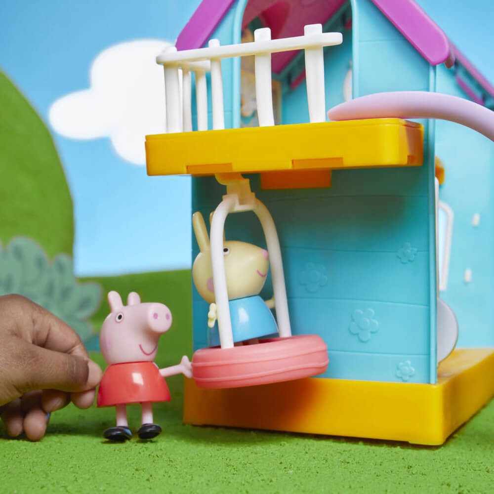 A plastic Peppa Pig toy play house standing on a table Stock Photo