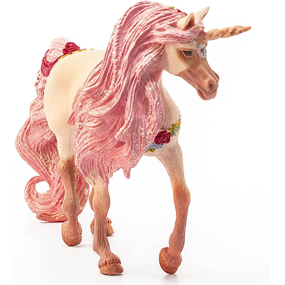 Schleich bayala decorated unicorn mare figure has a cream textured coat, glittery pink flowing mane and tail, golden horn, and floral accents, shown stepping forward on a white background.