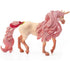 Schleich bayala unicorn mare toy features a cream-colored textured body, long sparkling pink mane and tail, gold spiral horn, and red floral ornaments in side view on white.