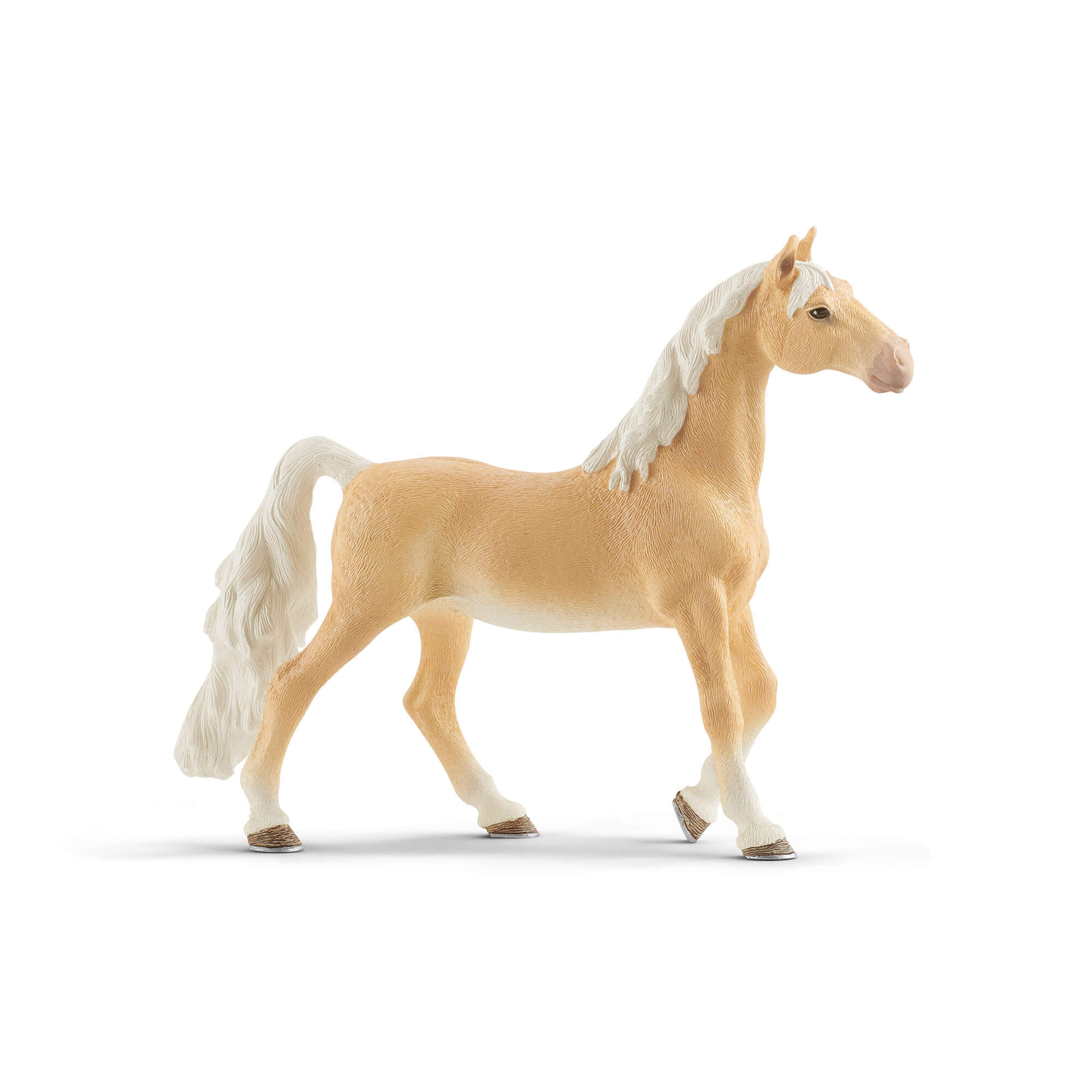 Golden tan Schleich Horse Club American Saddlebred mare figurine has a smooth textured coat, flowing white mane and raised tail, with one front leg lifted in a walking pose on a white background.