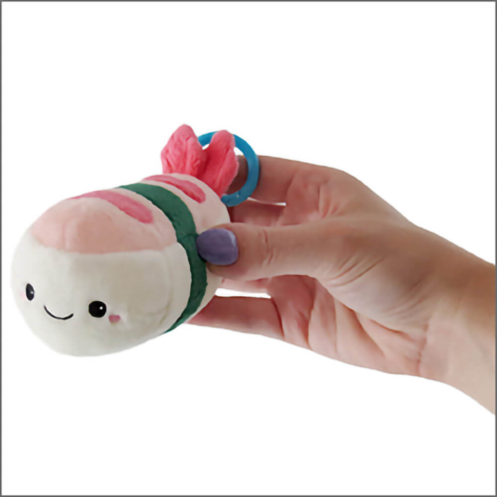 Person holding the Squishables Comfort Food Micro Shrimp Sushi plush keychain.